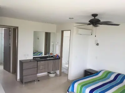 a bedroom with a bed and a ceiling fan at Casa de Playa en Marina Puerto Velero in Barranquilla