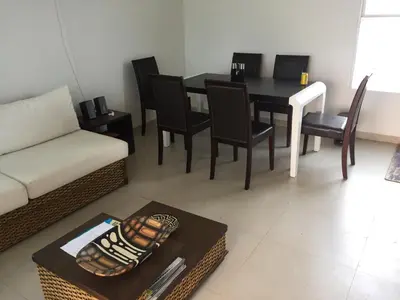 a living room with a couch and a table and chairs at Casa de Playa en Marina Puerto Velero in Barranquilla