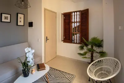 a living room with a couch and a table and a window at Ganem Suites Cartagena in Cartagena de Indias