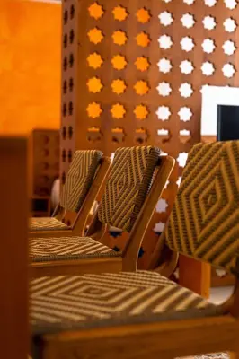 a row of chairs sitting in front of a wall at Ganem Suites Cartagena in Cartagena de Indias