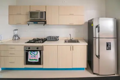 a kitchen with a refrigerator and a sink at Magico Apartamento Frente al Mar 3 Habitaciones AR44 in Coveñas