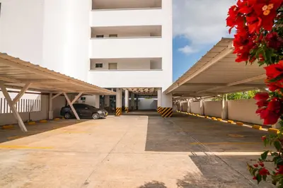a large white building with a parking lot at Magico Apartamento Frente al Mar 3 Habitaciones AR44 in Coveñas