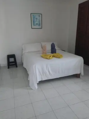 a teddy bear sitting on top of a bed at Vista al mar en Edificio Mar Adentro Bocagrande in Cartagena de Indias