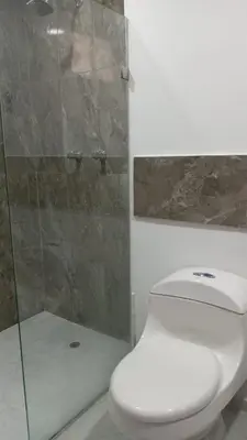 a bathroom with a toilet and a glass shower at Vista al mar en Edificio Mar Adentro Bocagrande in Cartagena de Indias