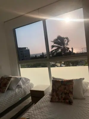 a bedroom with a bed and a large window at NUEVO PRECIOSO APARTAMENTO in Cartagena de Indias