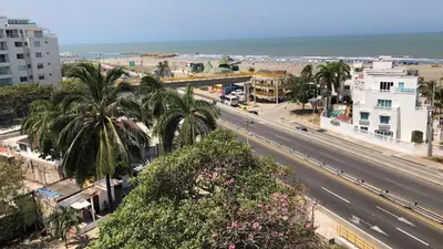 a city street with palm trees and the ocean at NUEVO PRECIOSO APARTAMENTO in Cartagena de Indias