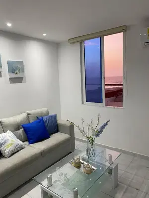 a living room with a couch and a glass table at Amazing ocean view Apartment in El Laguito Cartagena in Cartagena de Indias