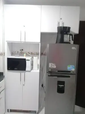 a kitchen with a refrigerator and a microwave at Amazing ocean view Apartment in El Laguito Cartagena in Cartagena de Indias