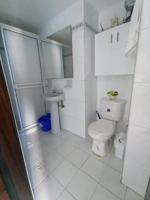 a white bathroom with a toilet and a sink at Amazing ocean view Apartment in El Laguito Cartagena in Cartagena de Indias