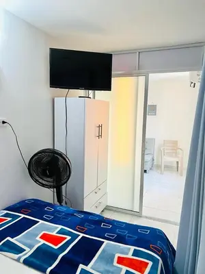 a bedroom with a bed with a blue comforter at Amazing ocean view Apartment in El Laguito Cartagena in Cartagena de Indias