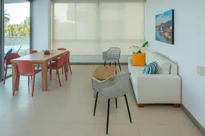 a dining room with a table and chairs and a couch at Magico Apartamento Frente al Mar 3 Habitaciones PAZ222 in Coveñitas