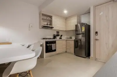 a kitchen with a refrigerator and a table and chairs at Morros ío Serena Del Mar - RNT 95283-523 in Cartagena de Indias