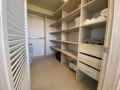 a walk in closet with wooden shelves and towels at Morros ío Serena Del Mar - RNT 95283-523 in Cartagena de Indias