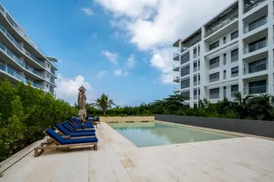 a group of blue lounge chairs next to a building at Morros ío Serena Del Mar - RNT 95283-523 in Cartagena de Indias