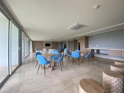 a restaurant with blue chairs and tables in a room at Morros ío Serena Del Mar - RNT 95283-523 in Cartagena de Indias