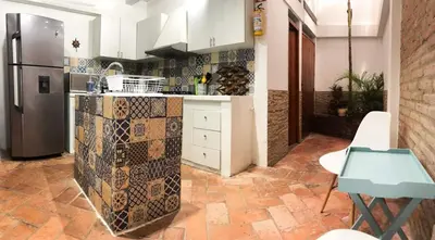 a kitchen with a refrigerator and a table in it at Casa Azulita RNT# 64888 in Cartagena de Indias