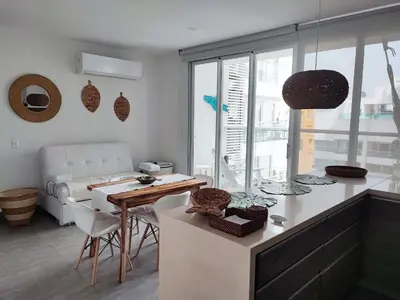 a kitchen with a table and a living room at Spiaggia di Cartagena primera línea de playa in Cartagena de Indias