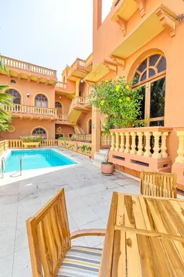 a house with a swimming pool and a wooden table at Casa Morales Getsemaní in Cartagena de Indias