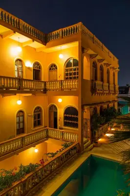 a large building with a swimming pool at night at Casa Morales Getsemaní in Cartagena de Indias