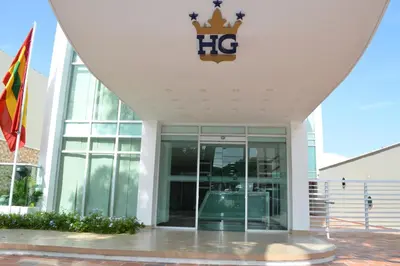 a building with a sign on top of it at Hotel Genova Prado in Barranquilla
