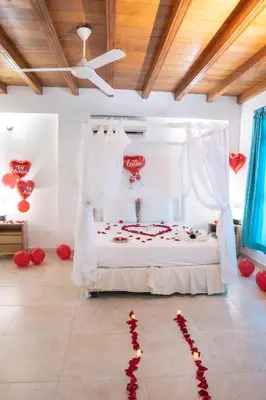 a bedroom with a bed with red hearts on the floor at hotel 3 banderas Manzanillo del Mar in Cartagena de Indias