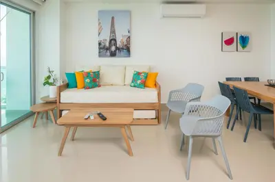 a living room with a couch and a table and chairs at Magico Apartamento Frente al Mar 3 Habitaciones AR91 in Pativilca