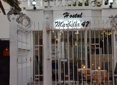 a restaurant with a table in front of a gate at Hostal Marbella 47 in Cartagena de Indias