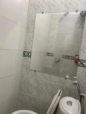 a bathroom with a shower with a toilet and a mirror at Hostal Marbella 47 in Cartagena de Indias