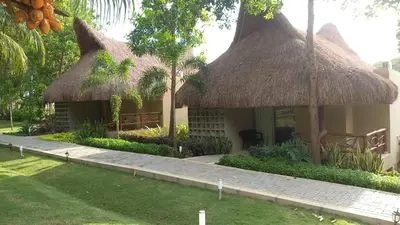 a small house with a thatched roof at La Bonita Luxury Ecohotel in Sahagún
