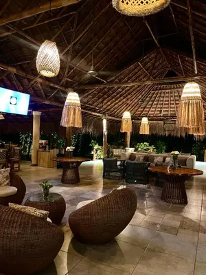 a lobby with couches and tables and chandeliers at La Bonita Luxury Ecohotel in Sahagún