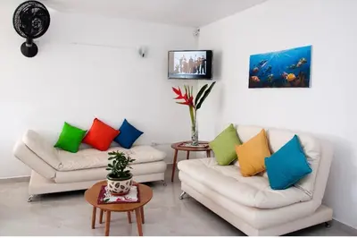 a living room with two couches and a tv at III NICE 2 BEDROOM APARTMENT Bocagrande in Cartagena de Indias