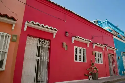 a red building in a street with colorful buildings at GREAT LOCATION ! 4 Bedroom Home in the Heart of Cartagena in Cartagena de Indias