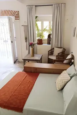 a bedroom with a large bed and chairs at GREAT LOCATION ! 4 Bedroom Home in the Heart of Cartagena in Cartagena de Indias