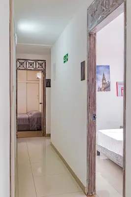 a bedroom with a bed and a mirror in a room at Luna Cartagena Airport Hotel in Cartagena de Indias