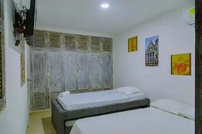 a bedroom with two beds and a window at Luna Cartagena Airport Hotel in Cartagena de Indias