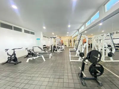 a gym with treadmills and machines in a room at Cartagena primera línea de playa azul frente al mar in Cartagena de Indias