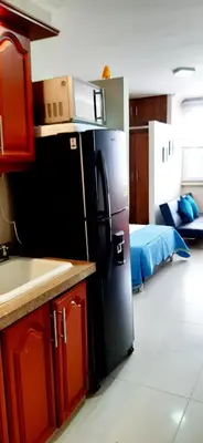 a kitchen with a black refrigerator in a room at Apto Nacaela-Bocagrande cerca a la playa in Cartagena de Indias