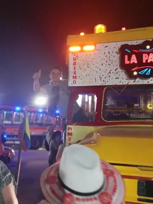 a man standing on the side of a bus at night at Apto Nacaela-Bocagrande cerca a la playa in Cartagena de Indias