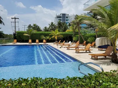 a swimming pool with lounge chairs next to a building at Morros Vitri memorable in Cartagena de Indias