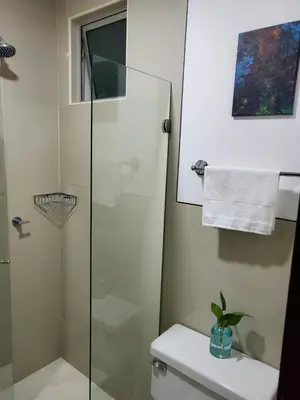 a bathroom with a glass shower and a toilet at Morros Vitri memorable in Cartagena de Indias