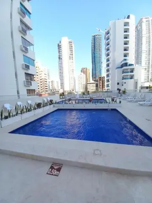 a swimming pool in the middle of a city with tall buildings at apartaestudio al lado del mar in Cartagena de Indias