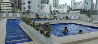 two children playing in a swimming pool on a building at apartaestudio al lado del mar in Cartagena de Indias