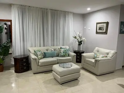 a living room with two couches and a table at SOL, ARENA, MAR, y PISCINA in Cartagena de Indias