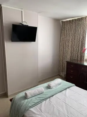 a bedroom with a bed with two towels on it at SOL, ARENA, MAR, y PISCINA in Cartagena de Indias