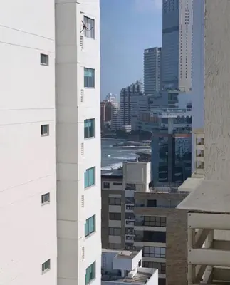 a view of a tall white building in a city at SOL, ARENA, MAR, y PISCINA in Cartagena de Indias