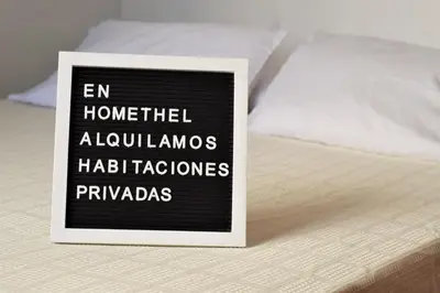 a sign sitting on top of a bed at HOMEthel in Cartagena de Indias