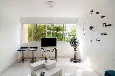 a white living room with a computer on a wall at HOMEthel in Cartagena de Indias
