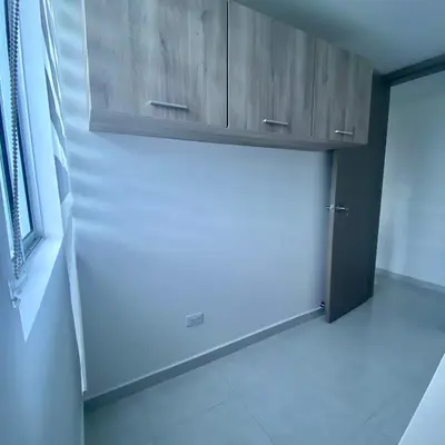 a white refrigerator in a room with a window at Hermoso Apartamento en Coveñas en unidad residencial in Coveñas