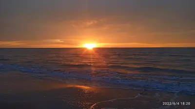 a sunset over the ocean with the sun setting at Cabaña frente al mar en moñitos, córdoba in Moñitos