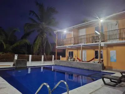 a swimming pool in front of a hotel at night at Cabaña frente al mar en moñitos, córdoba in Moñitos